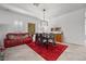 Dining room with modern light fixture, table, and adjacent living area at 723 Orange Plume Walk # 0, Henderson, NV 89011