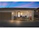 View of home featuring a 2-car garage and charming front porch with seating area at 723 Orange Plume Walk # 0, Henderson, NV 89011