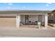 Property with a covered porch, a two-car garage, and a cozy outdoor seating area for relaxation and enjoyment at 723 Orange Plume Walk # 0, Henderson, NV 89011