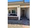 Charming front porch with brick accents and a cozy seating area to enjoy the outdoors at 723 Orange Plume Walk # 0, Henderson, NV 89011