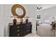 Hallway with a decorative mirror and dark wood dresser leading to a bedroom at 723 Orange Plume Walk # 0, Henderson, NV 89011