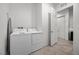 Bright laundry room featuring white washer and dryer set with an open doorway to the hallway at 723 Orange Plume Walk # 0, Henderson, NV 89011