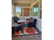 Comfortable covered outdoor patio with a colorful flower rug, wicker furniture, and an open view at 723 Orange Plume Walk # 0, Henderson, NV 89011
