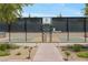 Pickleball court enclosed by a fence, with manicured landscaping around the court at 723 Orange Plume Walk # 0, Henderson, NV 89011