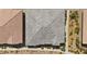 Aerial view of a modern roof displaying grey shingles and intricate design nestled among desert landscaping and neighboring houses at 723 Orange Plume Walk # 0, Henderson, NV 89011