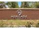 The Heritage community sign with brick wall and landscaping, marking the entrance to the neighborhood at 723 Orange Plume Walk # 0, Henderson, NV 89011