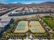 Aerial view of well-maintained community tennis courts surrounded by lush landscaping in a neighborhood at 723 Orange Plume Walk # 0, Henderson, NV 89011