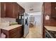 Galley kitchen featuring stainless steel refrigerator and tiled flooring at 7559 Silver Leaf Way, Las Vegas, NV 89147