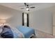 Cozy bedroom with blue bedding and ceiling fan at 7675 W Mistral Ave, Las Vegas, NV 89113