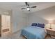 Simple bedroom with blue bedding and ceiling fan at 7675 W Mistral Ave, Las Vegas, NV 89113