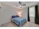 Serene bedroom featuring blue bedding and dark curtains at 7675 W Mistral Ave, Las Vegas, NV 89113