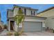 Two-story house with gray siding, gray garage door, and dark brown window shutters at 7675 W Mistral Ave, Las Vegas, NV 89113