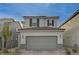 Two-story house with gray siding, gray garage door, and dark brown window shutters at 7675 W Mistral Ave, Las Vegas, NV 89113