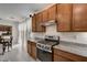 Modern kitchen with stainless steel appliances and granite countertops at 7675 W Mistral Ave, Las Vegas, NV 89113