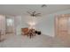 Living room features a tan couch and a ceiling fan at 7675 W Mistral Ave, Las Vegas, NV 89113