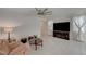 Living room with a large TV, fireplace, and seating area at 7675 W Mistral Ave, Las Vegas, NV 89113