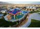 Aerial view of community amenities including pool, playground, and clubhouse at 8136 Little Skye Ct, Las Vegas, NV 89166