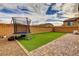 Backyard with artificial turf, trampoline, and patio at 8136 Little Skye Ct, Las Vegas, NV 89166