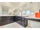 Double vanity bathroom with dark brown cabinets and large mirror at 8136 Little Skye Ct, Las Vegas, NV 89166