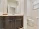 Clean bathroom with dark vanity and white toilet at 8136 Little Skye Ct, Las Vegas, NV 89166