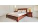 Main bedroom with wood furniture and neutral bedding at 8136 Little Skye Ct, Las Vegas, NV 89166