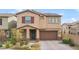 Two-story house with brown garage door and landscaped yard at 8136 Little Skye Ct, Las Vegas, NV 89166