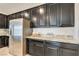 Kitchen boasts stainless steel refrigerator and granite countertops at 8136 Little Skye Ct, Las Vegas, NV 89166
