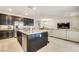 Modern kitchen with island, stainless steel appliances, and dark cabinets at 8136 Little Skye Ct, Las Vegas, NV 89166