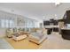 Open concept living area with kitchen and sectional sofa at 8136 Little Skye Ct, Las Vegas, NV 89166