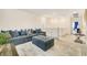 Comfortable living room with sectional sofa and ottoman at 8136 Little Skye Ct, Las Vegas, NV 89166