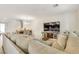 Open floorplan with sectional sofa and dining area at 8136 Little Skye Ct, Las Vegas, NV 89166