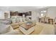 Open living space with large sectional sofa, coffee table, and adjacent kitchen at 8136 Little Skye Ct, Las Vegas, NV 89166