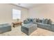 Relaxing living room with sectional sofa and ottoman at 8136 Little Skye Ct, Las Vegas, NV 89166