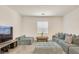 Spacious living room with sectional sofa and large TV at 8136 Little Skye Ct, Las Vegas, NV 89166