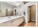 Bathroom showcasing double sinks, tile flooring, and a walk-in shower at 830 Cozette Ct # 102, Las Vegas, NV 89144