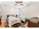 Bedroom with two twin beds, ceiling fan and wood flooring at 830 Cozette Ct # 102, Las Vegas, NV 89144