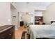 Bedroom featuring hardwood floors, ceiling fan, and closet with mirrored doors at 830 Cozette Ct # 102, Las Vegas, NV 89144
