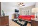 Cozy bedroom with ceiling fan, fireplace, and hardwood floors at 830 Cozette Ct # 102, Las Vegas, NV 89144