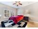 Comfortable bedroom with ceiling fan, two shuttered windows and hardwood floors at 830 Cozette Ct # 102, Las Vegas, NV 89144