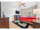 Cozy bedroom with ceiling fan, fireplace, and hardwood floors at 830 Cozette Ct # 102, Las Vegas, NV 89144