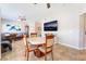 Inviting dining area features tile flooring, a round table with seating for four, and a mounted television at 830 Cozette Ct # 102, Las Vegas, NV 89144