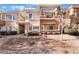 Attractive townhome with a mix of stucco and siding, a covered patio, and a professionally landscaped yard at 830 Cozette Ct # 102, Las Vegas, NV 89144