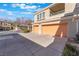 Two-car garage with spacious driveway and well-maintained landscaping, enhancing the home's curb appeal at 830 Cozette Ct # 102, Las Vegas, NV 89144