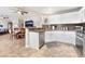Open kitchen featuring stainless steel appliances, white cabinets, and a breakfast bar at 830 Cozette Ct # 102, Las Vegas, NV 89144