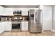 Well-equipped kitchen with stainless steel appliances and white cabinets, including a refrigerator with water dispenser at 830 Cozette Ct # 102, Las Vegas, NV 89144