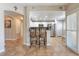 Bright kitchen showcasing a breakfast bar with seating and modern stainless steel appliances at 830 Cozette Ct # 102, Las Vegas, NV 89144