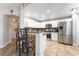Well-lit kitchen boasts white cabinetry, stainless steel appliances, and a breakfast bar with seating at 830 Cozette Ct # 102, Las Vegas, NV 89144