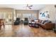Bright living room boasts tile flooring, ceiling fan, many windows and a brown leather sofa at 830 Cozette Ct # 102, Las Vegas, NV 89144