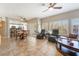 Open-concept living space with ceiling fan, breakfast bar, tile flooring, and sliding doors to the patio at 830 Cozette Ct # 102, Las Vegas, NV 89144