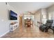Open-concept living space features modern decor, tile flooring, and access to the dining area at 830 Cozette Ct # 102, Las Vegas, NV 89144